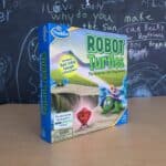 Robot Turtles board game displayed in front of a chalkboard.