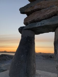inuksuk in front of a sunset