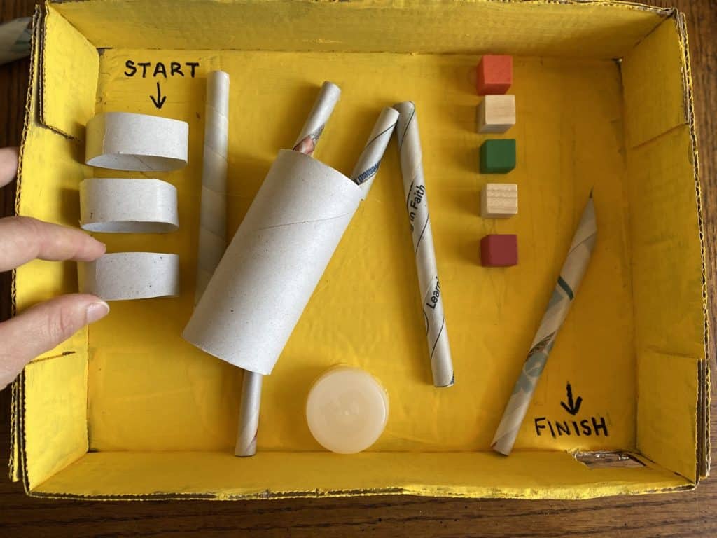 Various materials laid out in a yellow box.