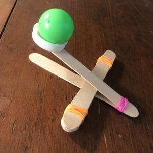 A DIY catapult created with popsicle sticks.