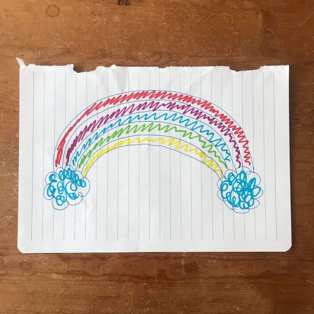 A rainbow drawn on a lined piece of paper.
