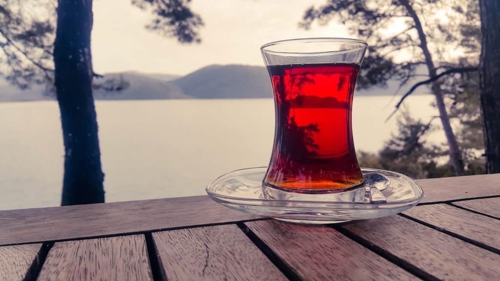 Tea sitting on a wooden table, looking out over the lake.