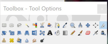 The toolbox in GIMP which contains small icons for the different tools available with the blade tool is highlighted.