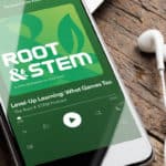 Smart phone with a set of headphones displaying "Root & STEM podcast" cover art.