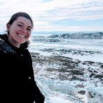 Danielle Moore smiling in front of mountains.