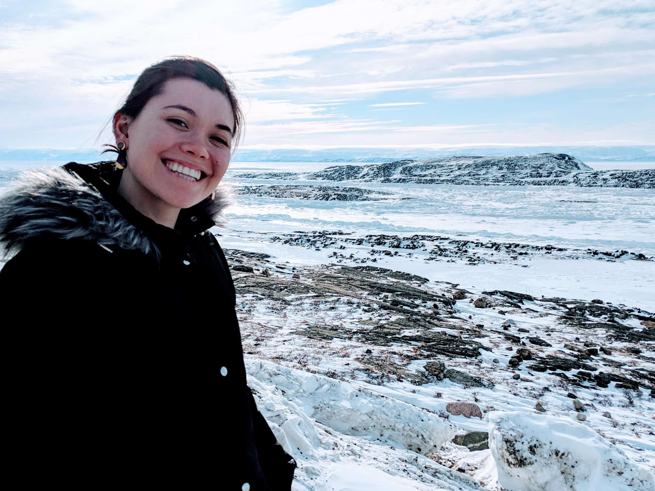 Danielle Moore smiling in front of mountains.