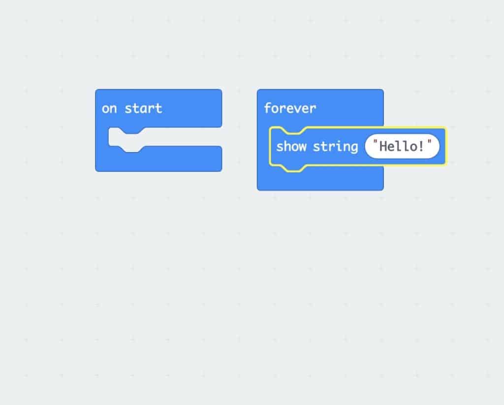 an empty “start” loop beside a “forever” loop with the ‘Show String “Hello” ‘ block inside
