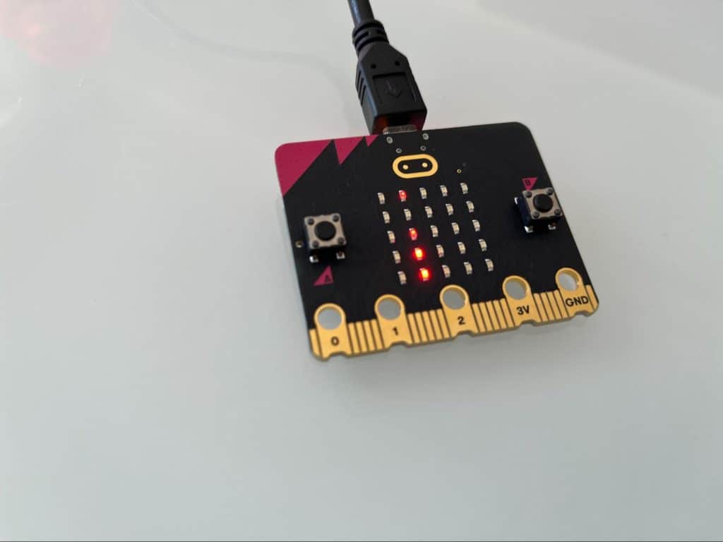 Micro:Bit with led lights lit up showing the start of a word