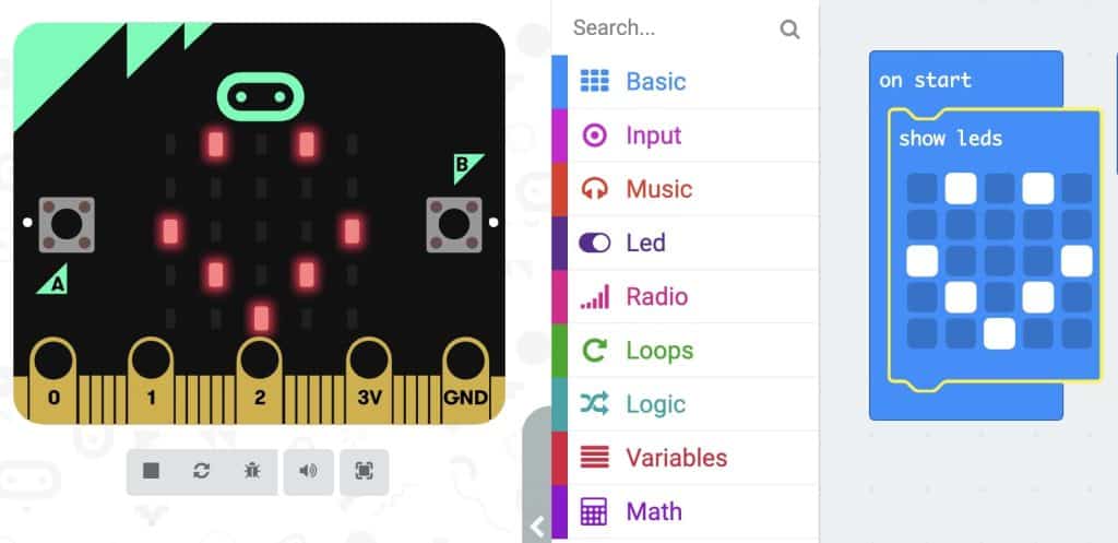 Micro:Bit with LEDs lit up in the shape of a smile face beside the image of the code ‘On start’ Loop with ‘Show LEDs’ block inside. The ‘Show LEDs’ block has LED squares clicked on in the shape of a smile face
