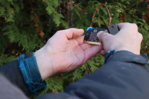 Two hands holding a micro:bit.